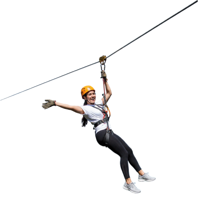 rider flying down a giant zip line over a valley